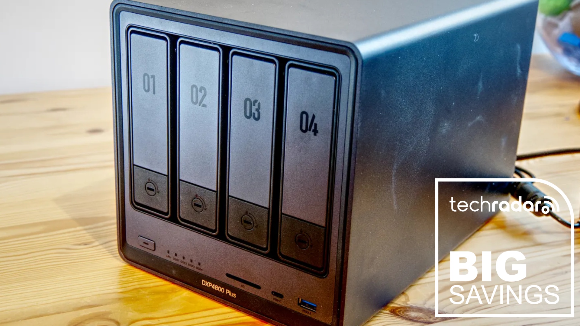 The Ugreen DXP4800 Plus during our hands-on testing, next to a white TechRadar badge in the lower right corner that reads 'Big Savings'