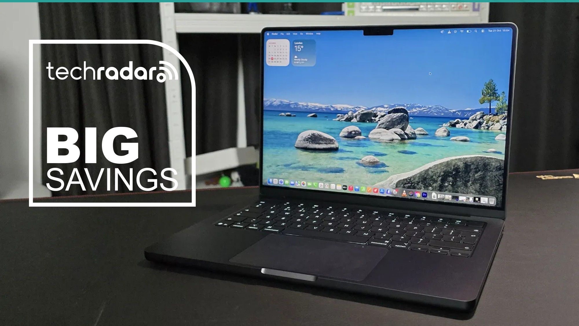 The MacBook Pro 14-inch (M5) during our tests in a home office, next to a TechRadar badge that reads 'Big Savings'