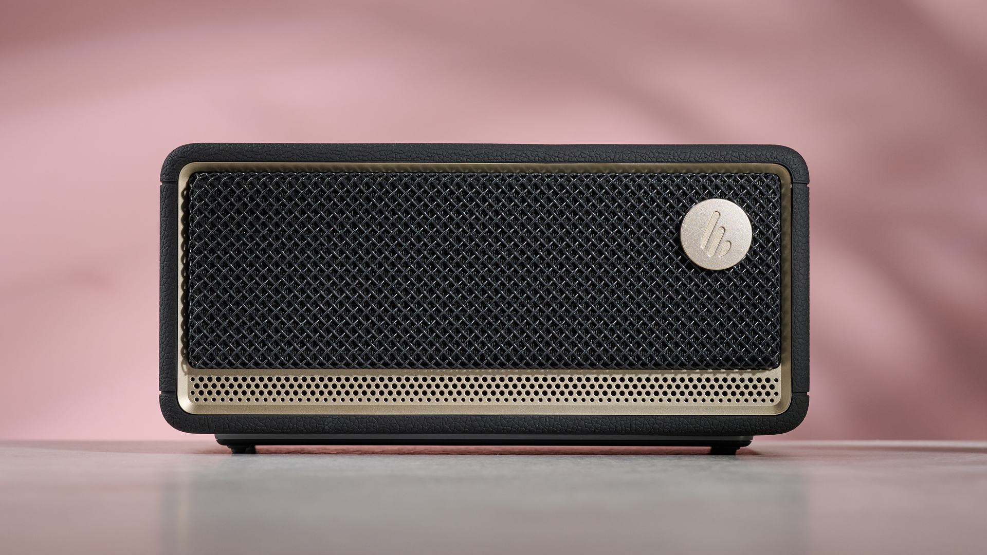 Edifier ES60 on table, against pink background with lights active