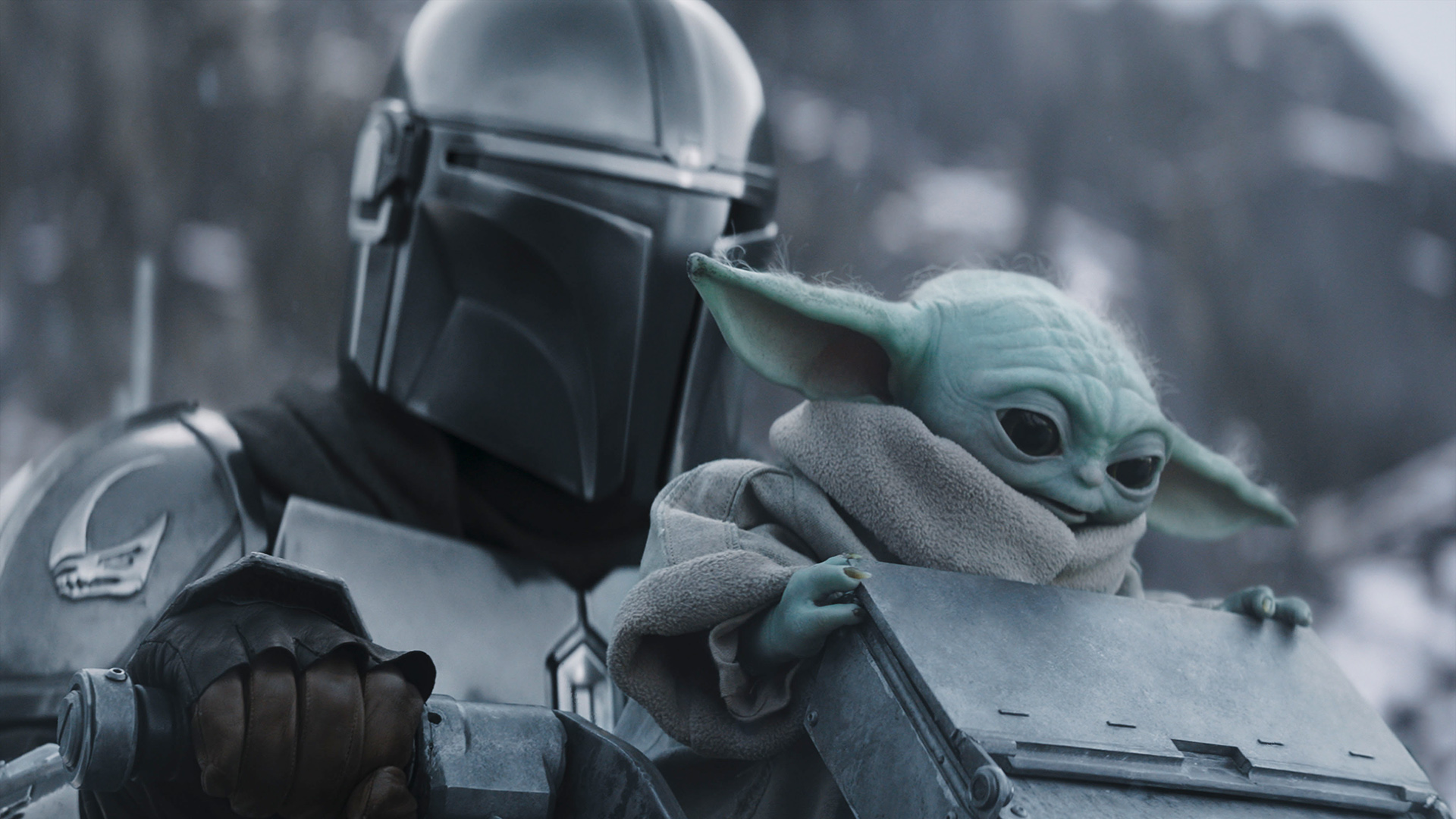 A close up of Din Djarin and Baby Yoda in The Mandalorian and Grogu