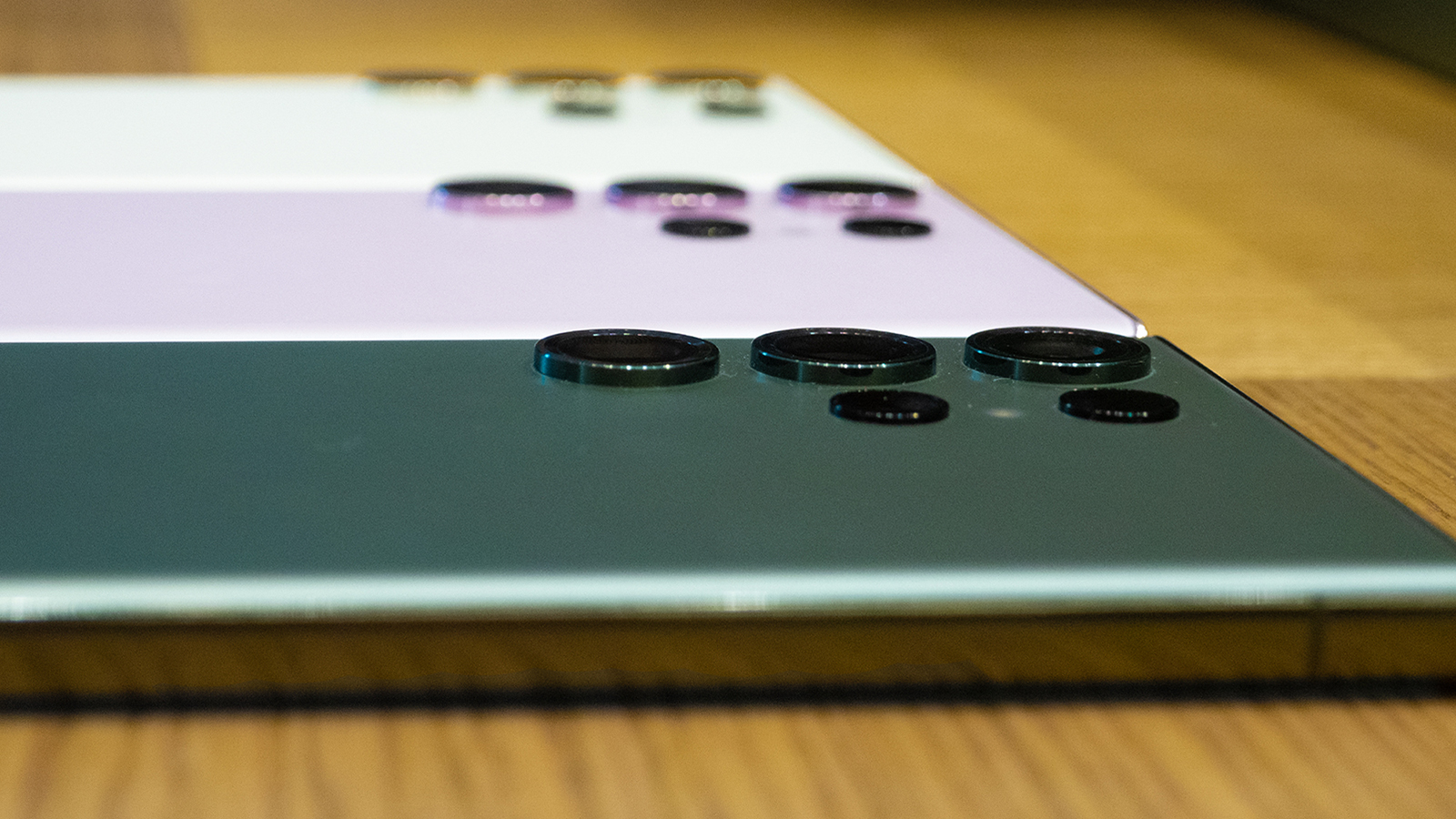 Three Samsung Galaxy S23 Ultra handsets in a row lying down