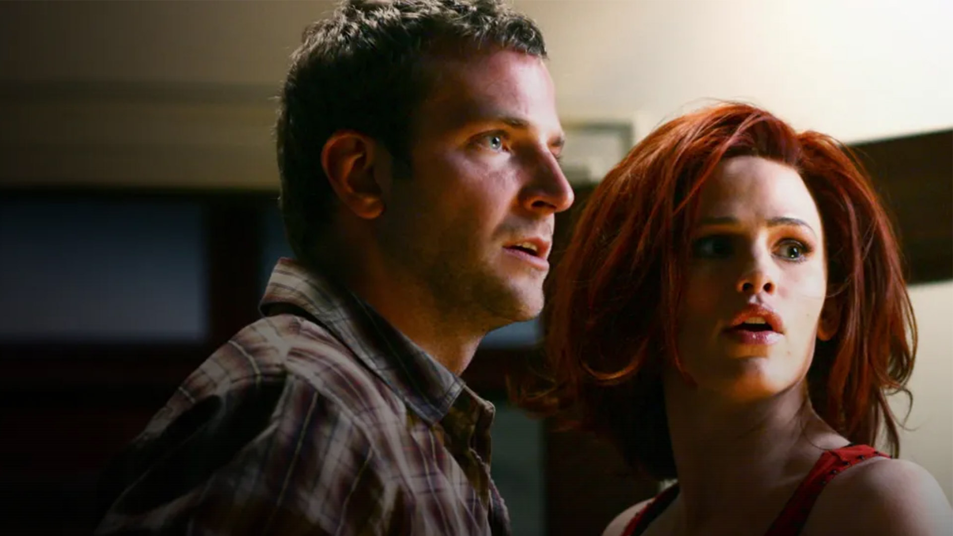 Two people look to the right in a room in Alias