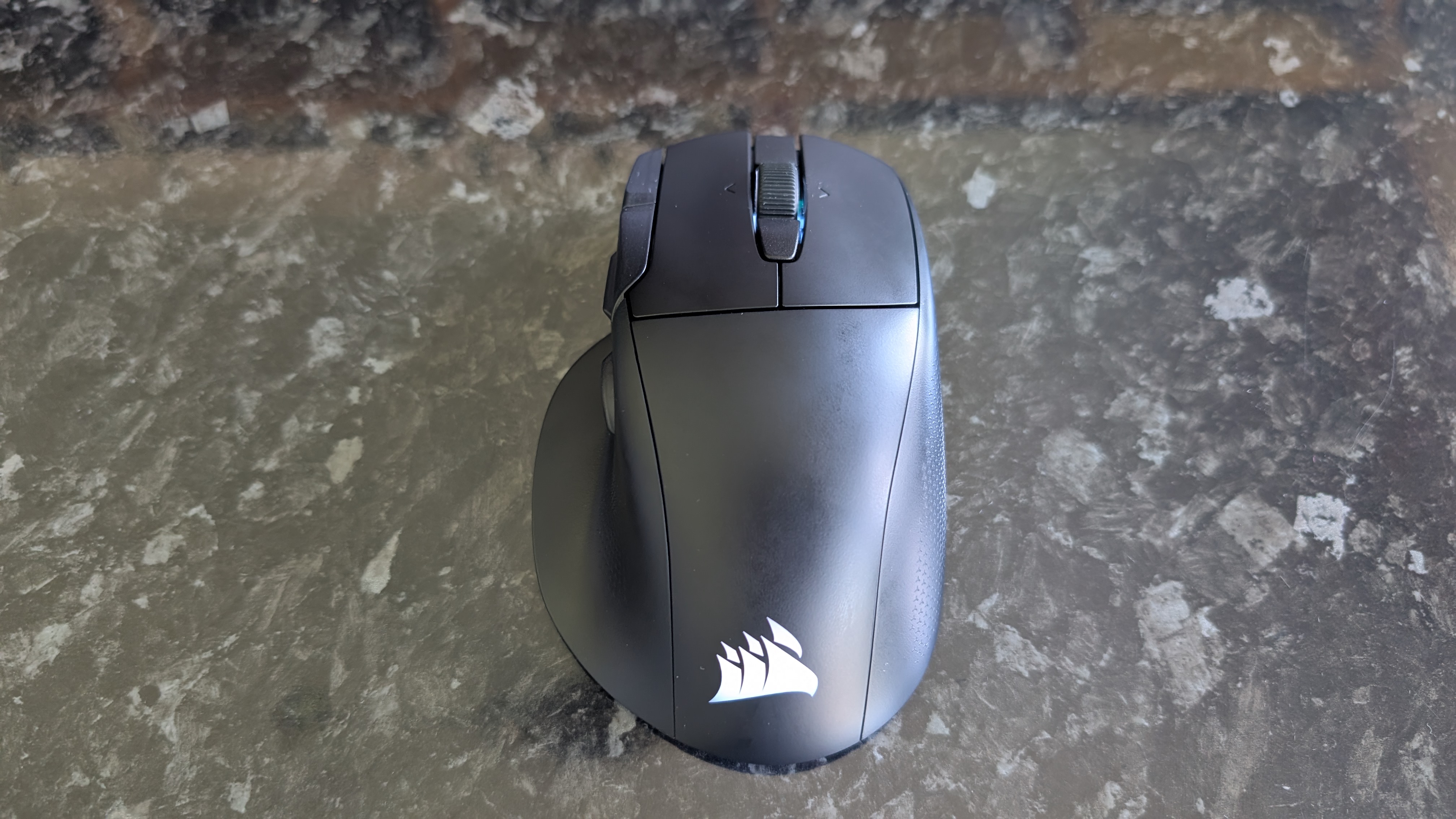 The Corsair Nightsword V2 Wireless gaming mouse pictured on a black marble worktop.