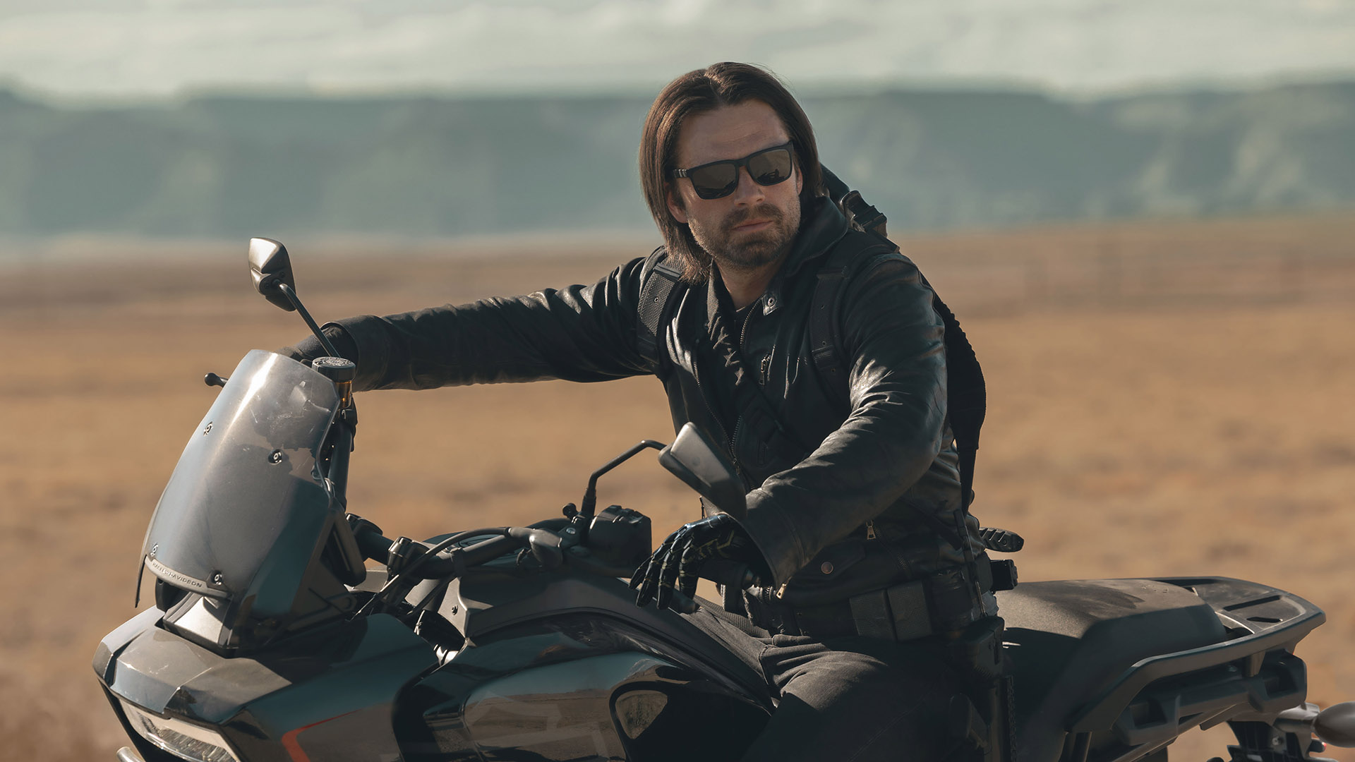 Bucky Barnes sitting on a motorbike in the Utah desert in Marvel's Thunderbolts* movie