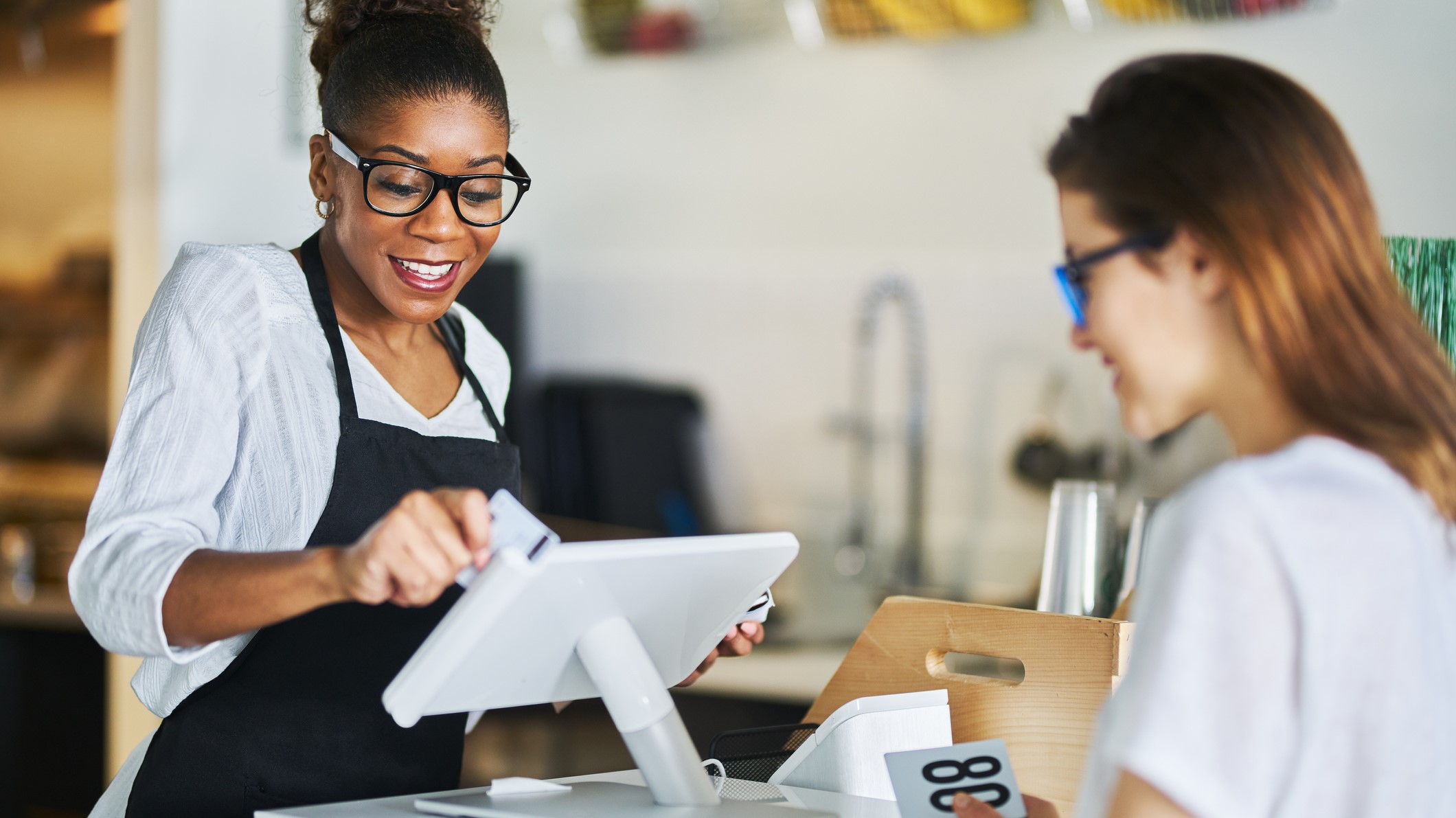 Food SMB owner uses white POS system with customer