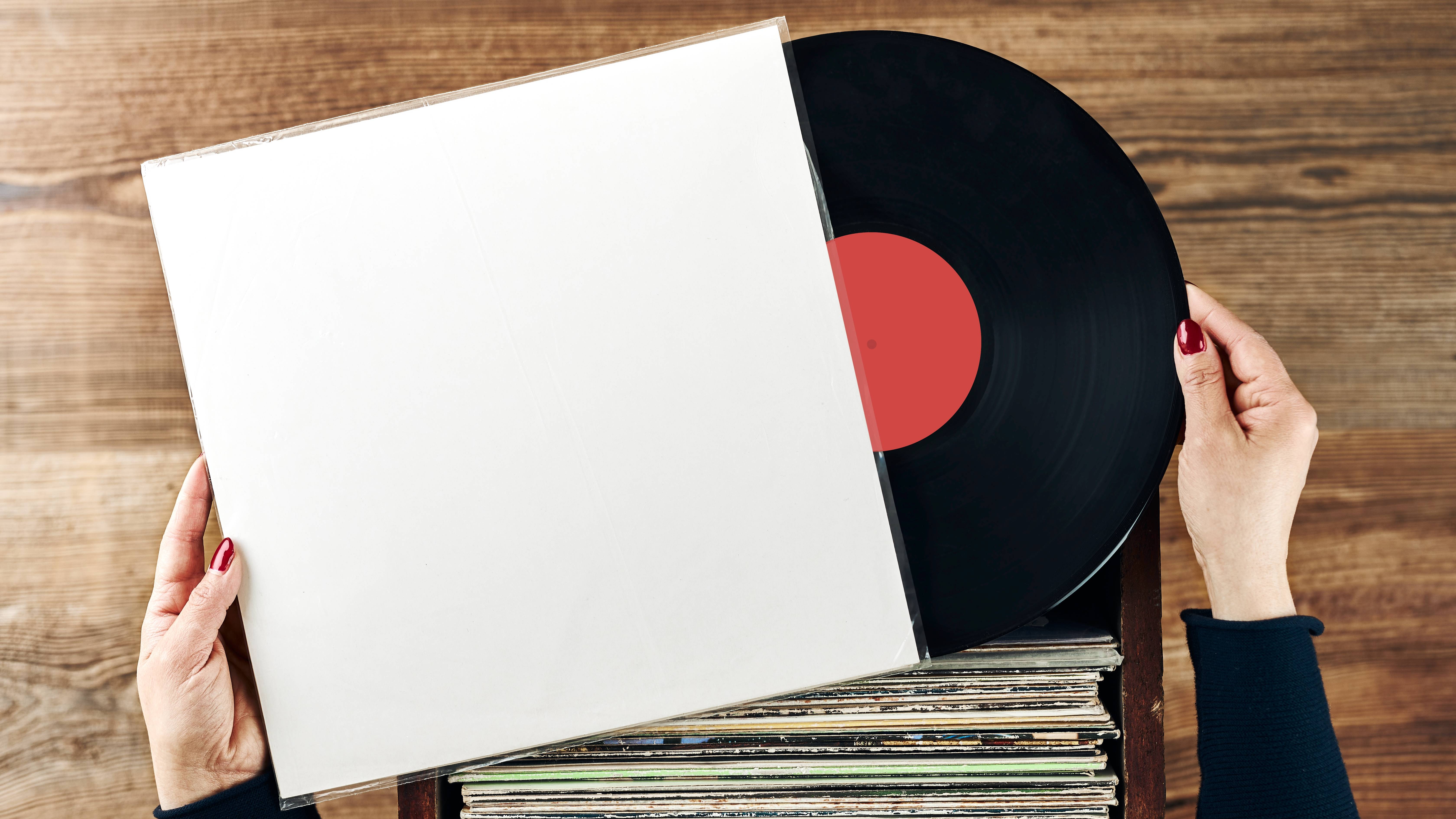 Someone taking a vinyl record out of the sleeve