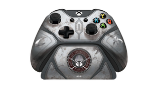 Product render of a gray xbox controller with a charging stand, themed after Mandalorian armor