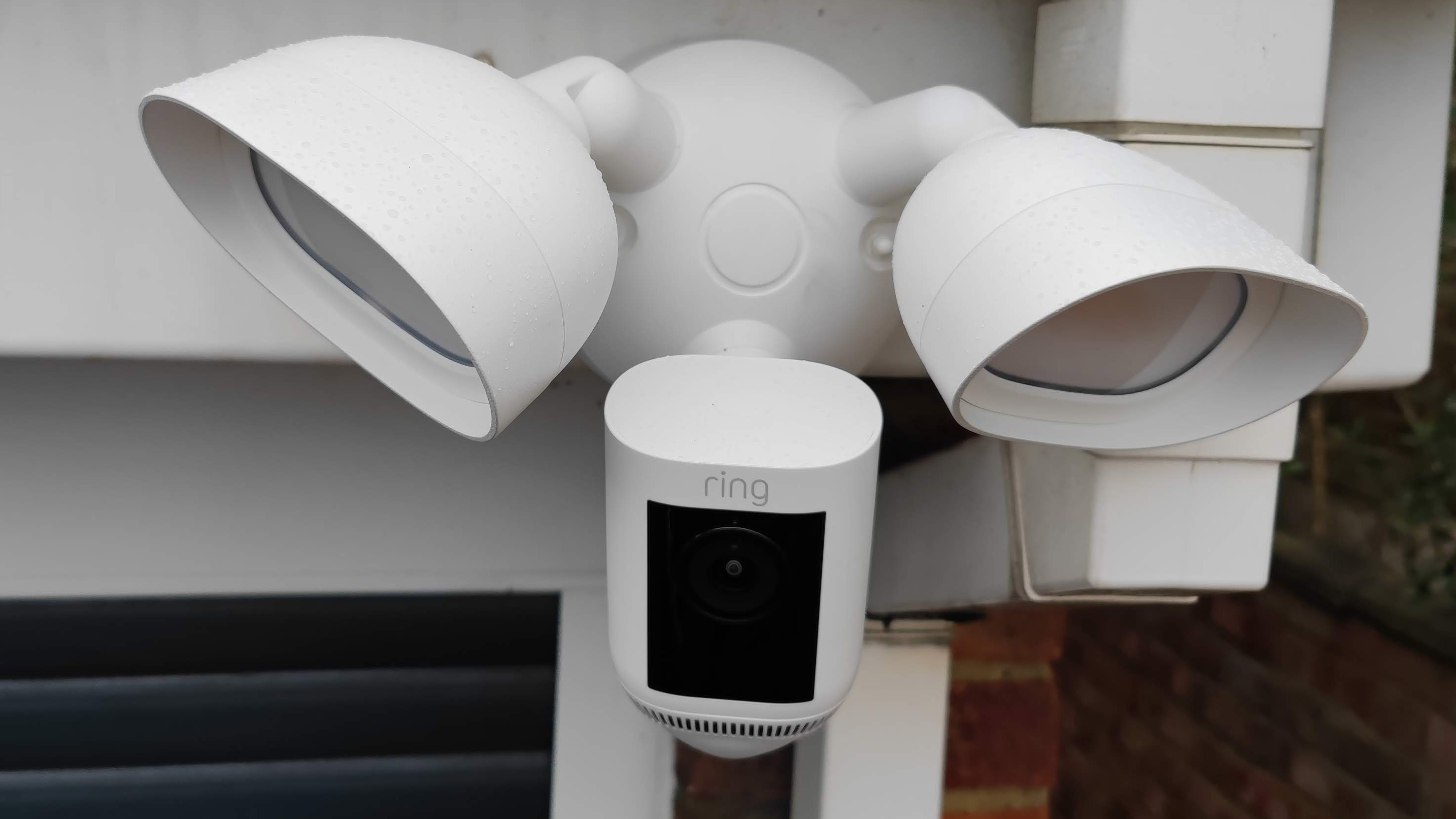 The Ring Floodlight Cam Pro Wired mounted on the exterior of a building