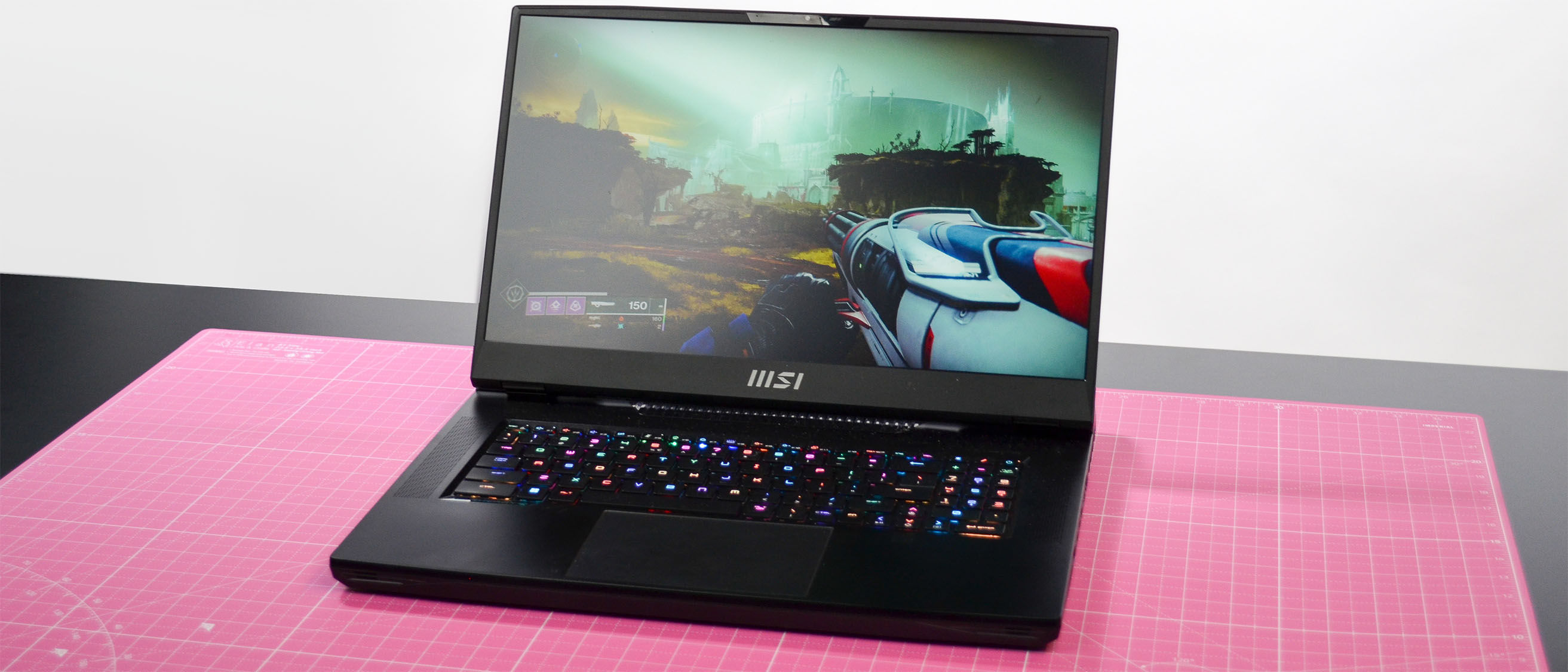 An MSI GT77 Titan on a pink desktop mat