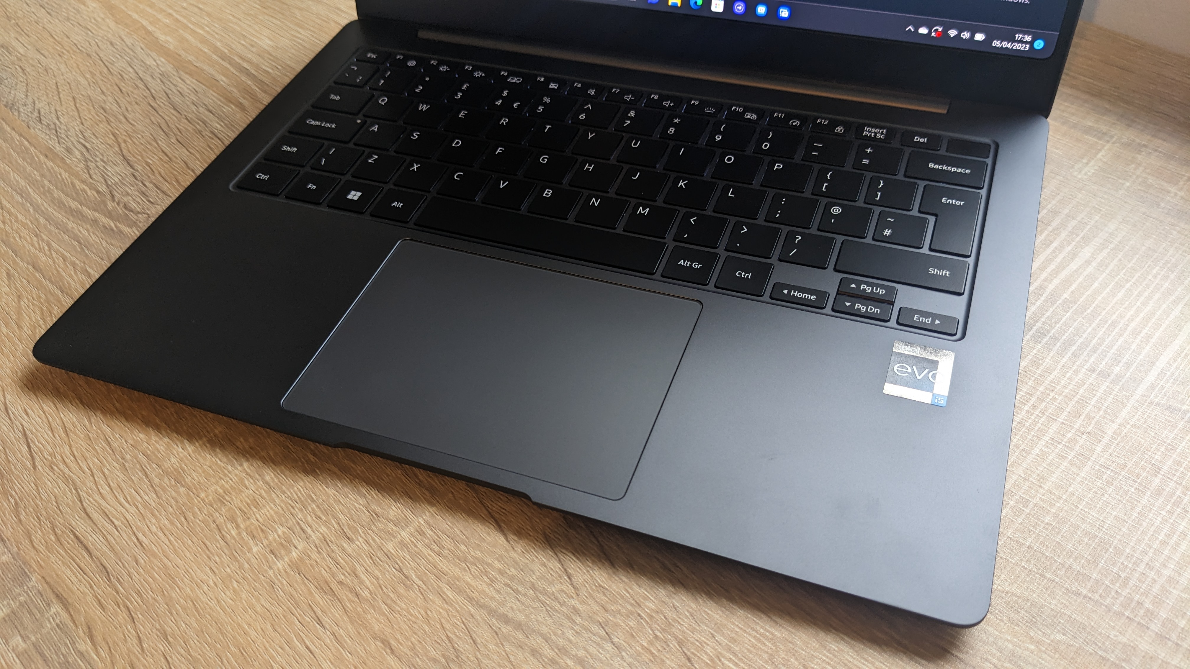 The Samsung Galaxy Book3 Pro 14-inch laptop pictured atop a wooden desk.