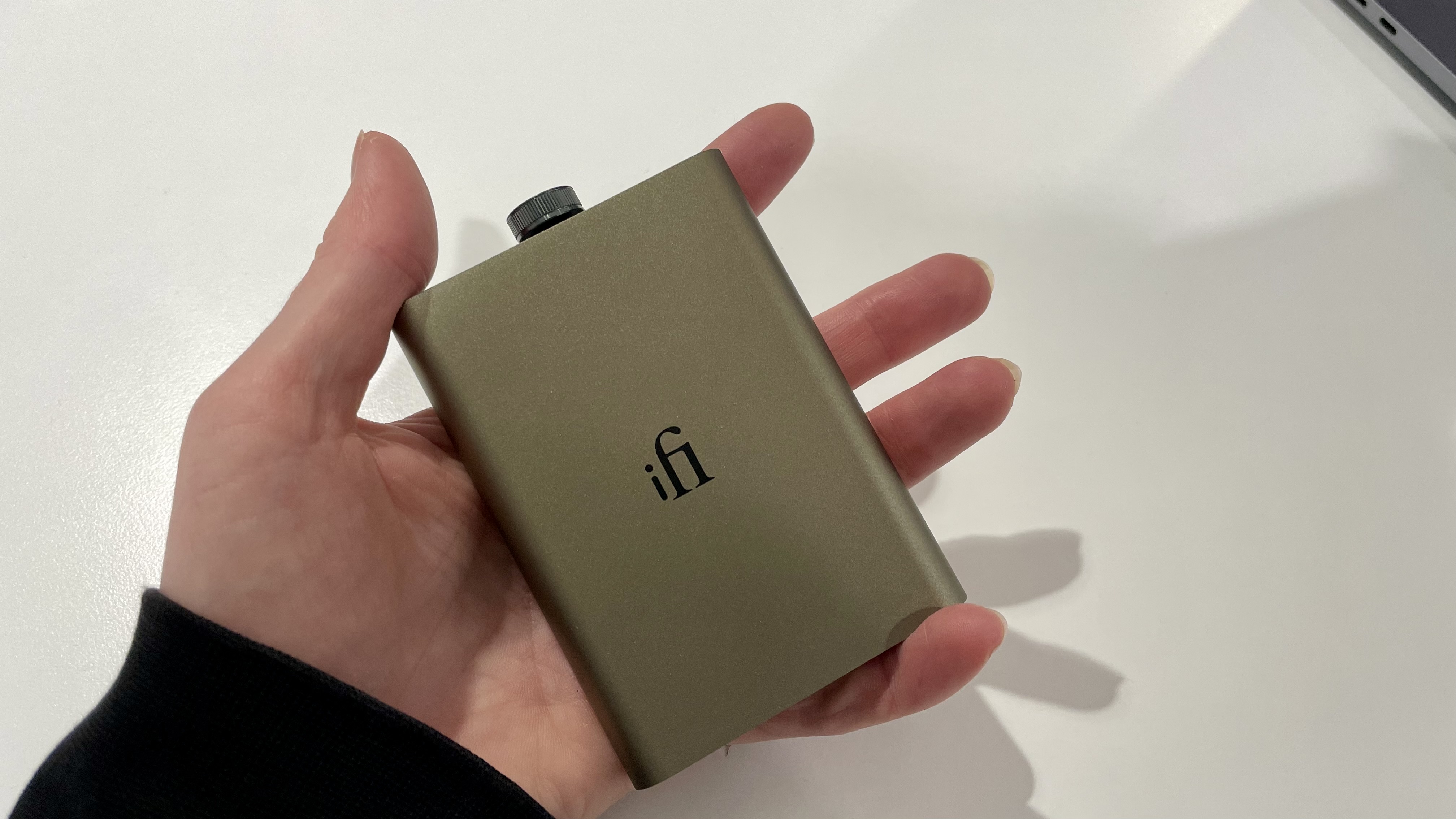 iFi hip-dac 3 held in hand on white background