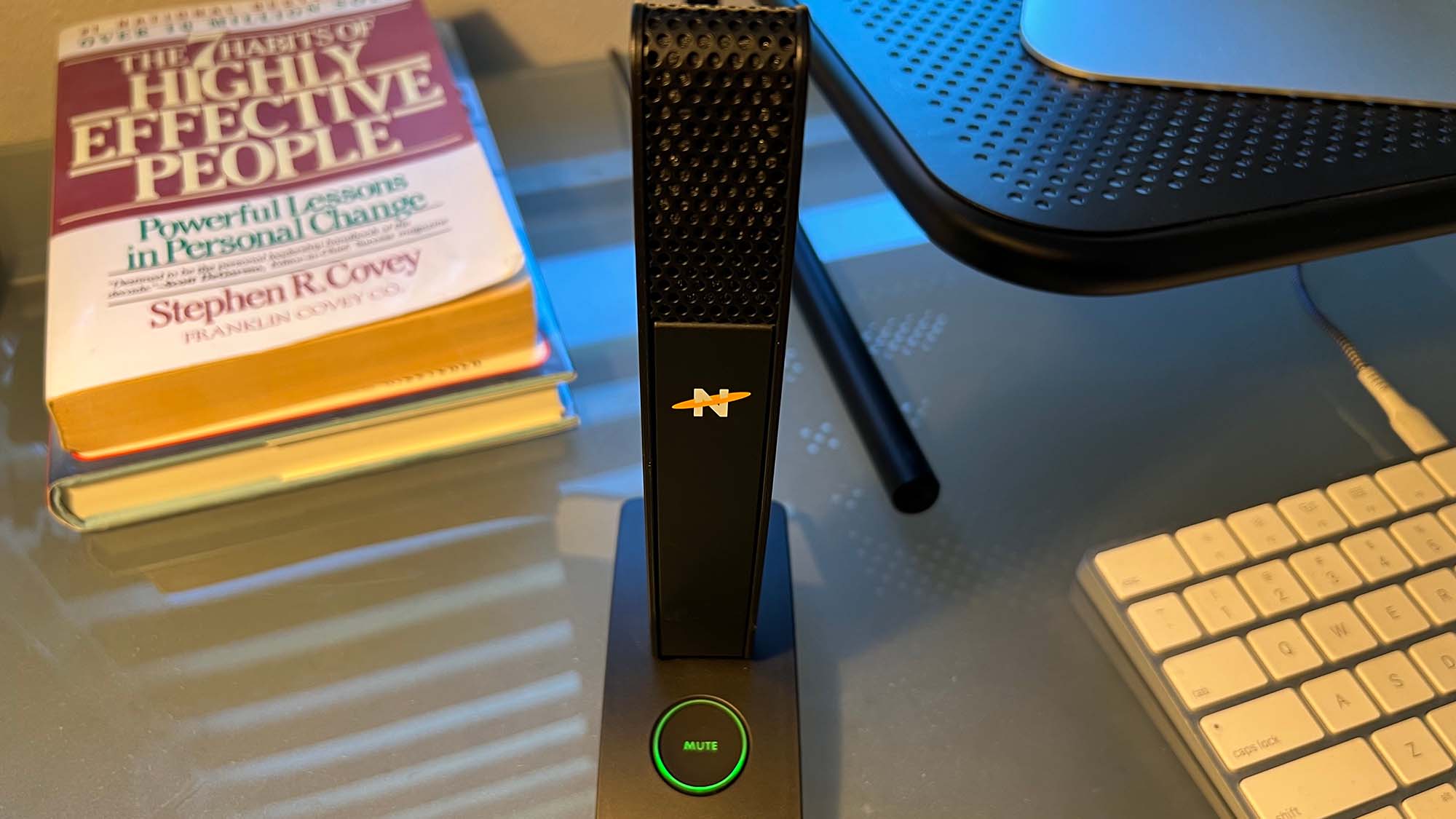 A Neat Skyline mocrophone on a desk during a conference call