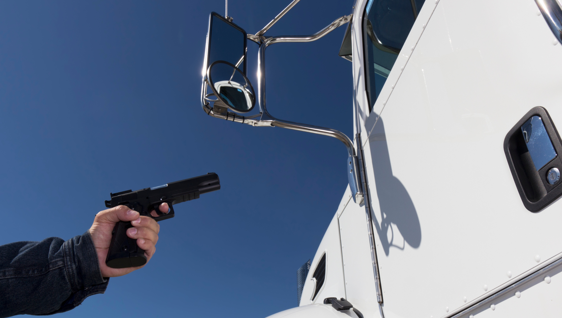 Man robbing a truck with a handgun