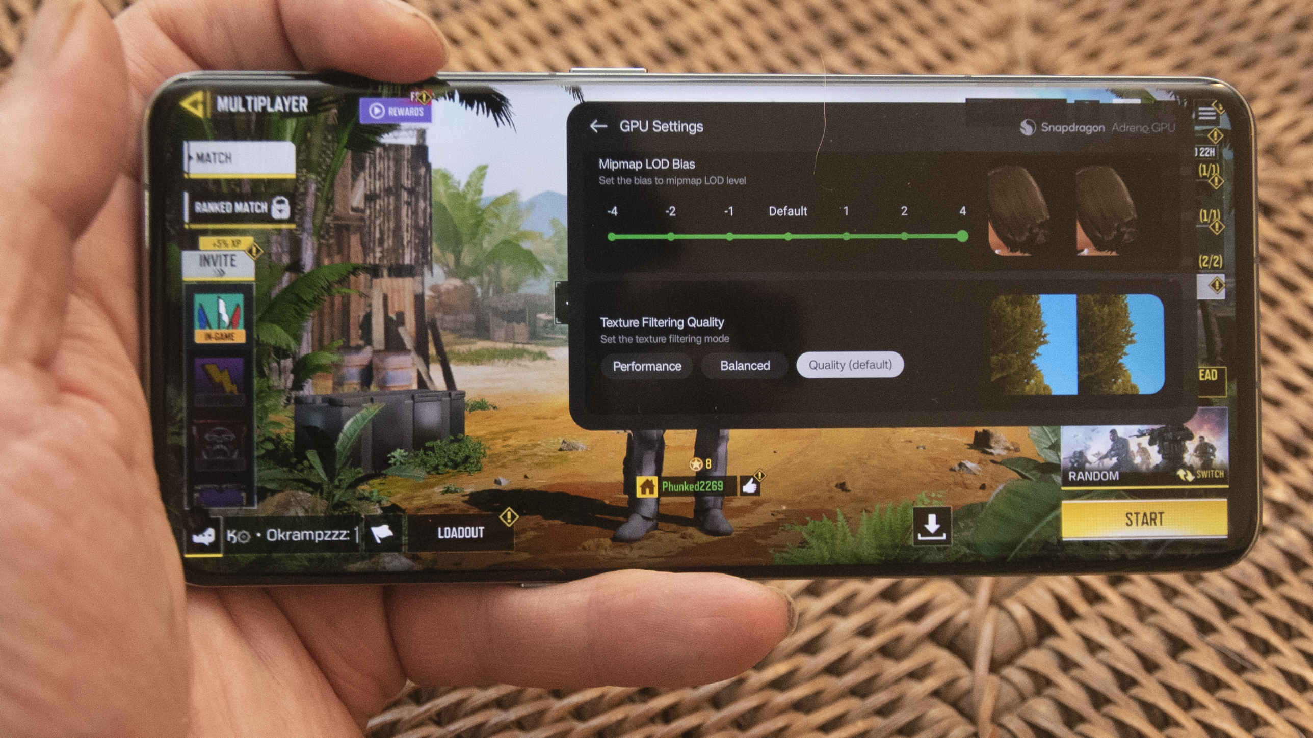 OnePlus 11 in green on wicker basket top with screen on