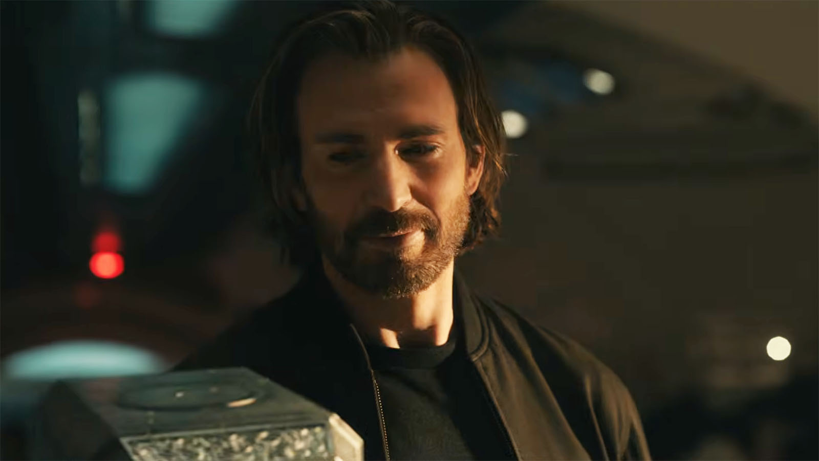 Chris Evans' Steve Rogers smiling as he looks down at Mjolnir in Avengers: Doomsday