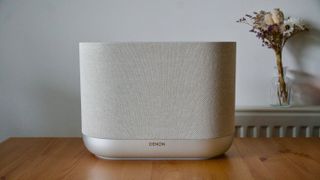 Denon Home 400 home speaker on a wooden surface