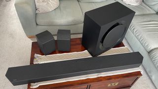 The Samsung HW-Q990C soundbar system pictured in a living room on a wooden table