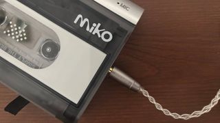 A close-up of the Miko cassette player by Gadhouse with wired earbuds plugged in