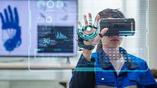 A female worker using a VR headset in an office in front of a futuristic display