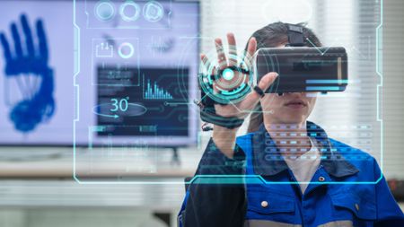 A female worker using a VR headset in an office in front of a futuristic display
