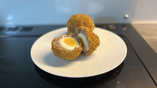 air fryer scitch eggs on a plate in the kitchen