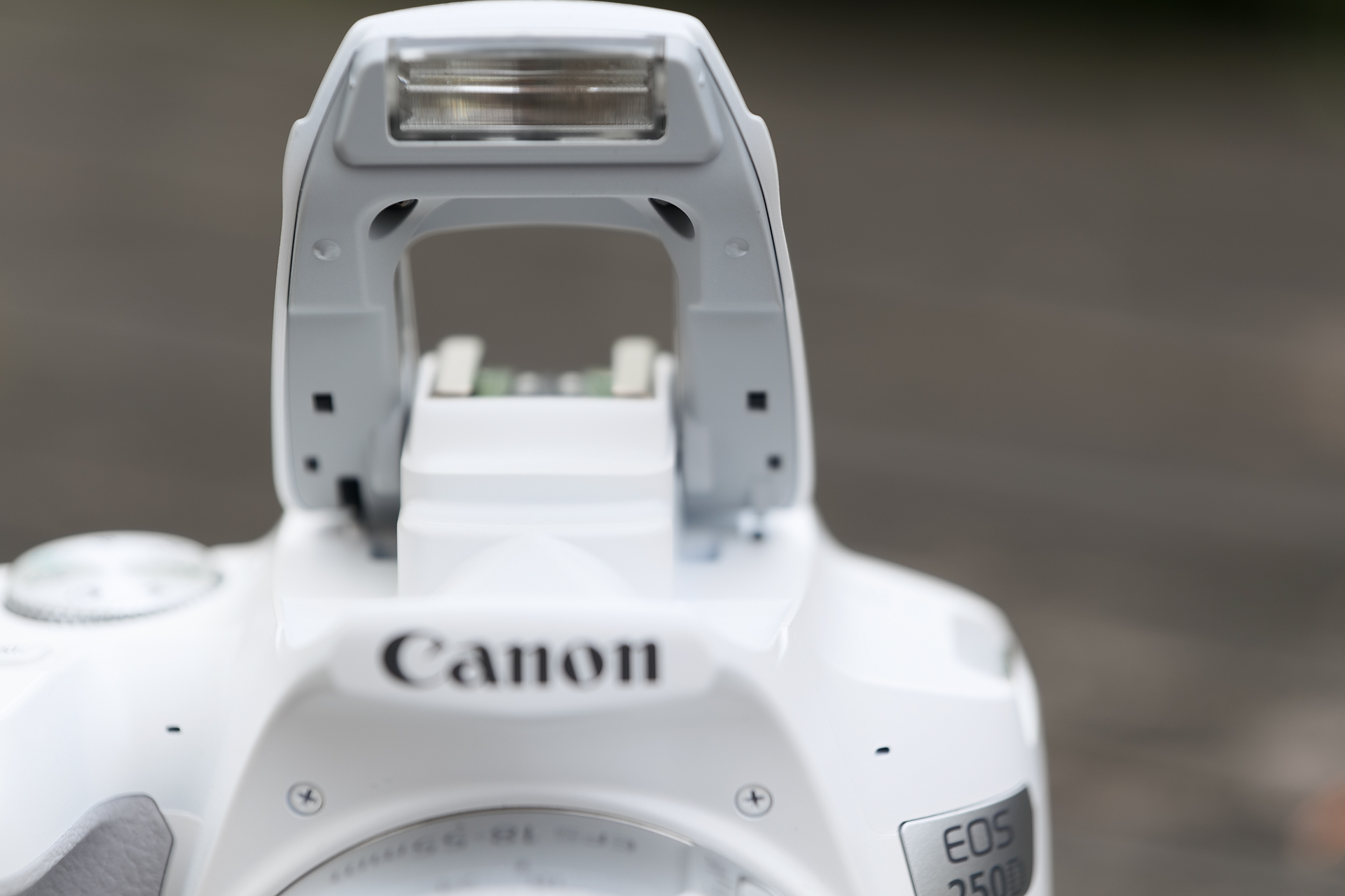 There's no longer a dedicated flash button on the body; instead, the flash is raised manually via one of two notches at its side. Image credit: TechRadar