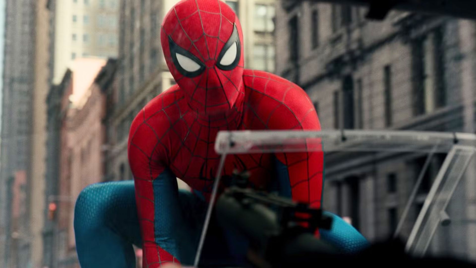 Spider-Man lands on a car