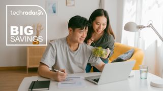 Young Asian couple working together from home. They are wearing casual clothes and eating healthy food. TechRadar deal badge on top left corner