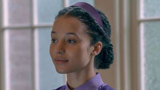 Agnes stares at something offscreen