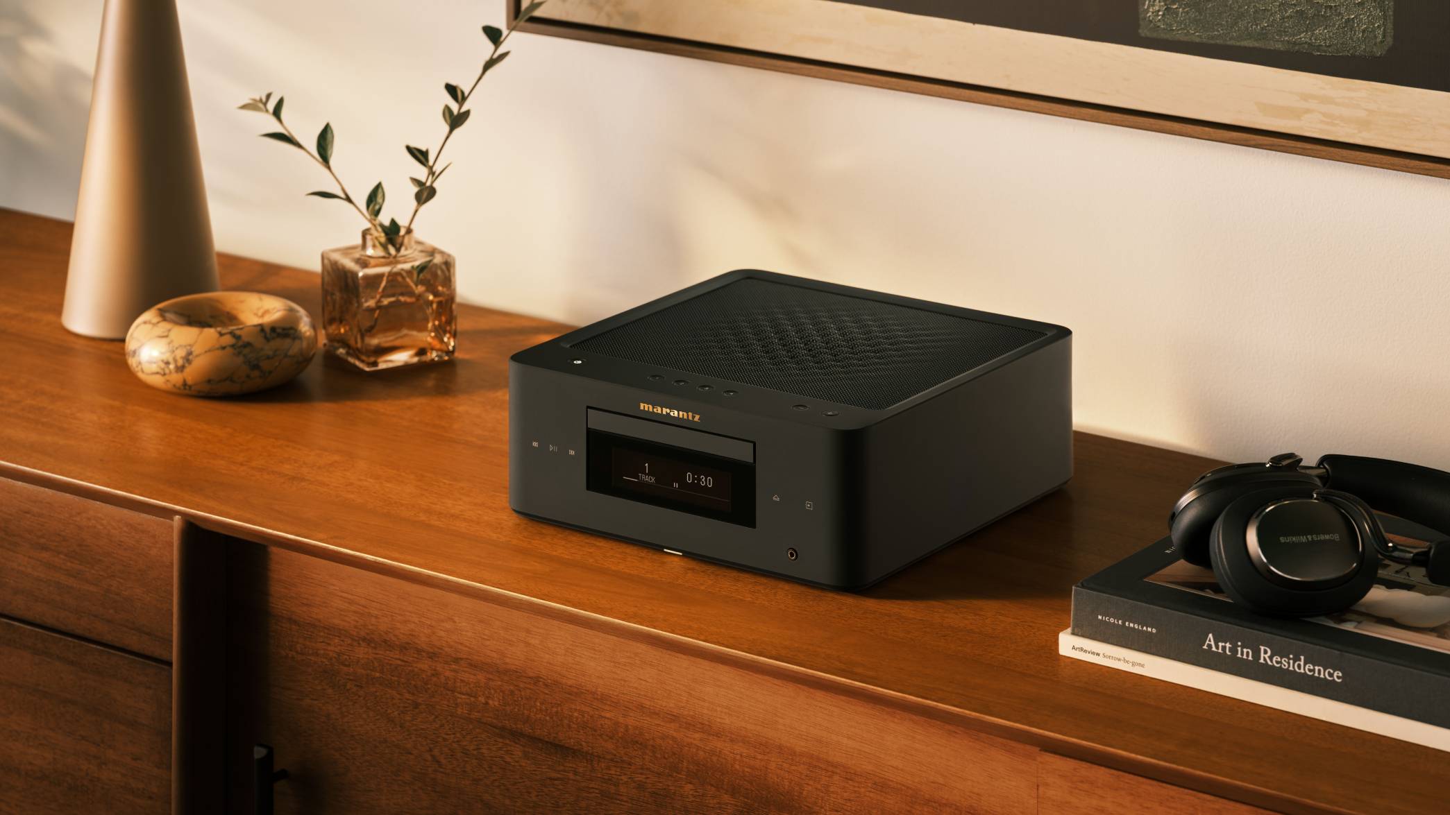 The Marantz MCR 60n on a wooden shelf, next to some headphones.