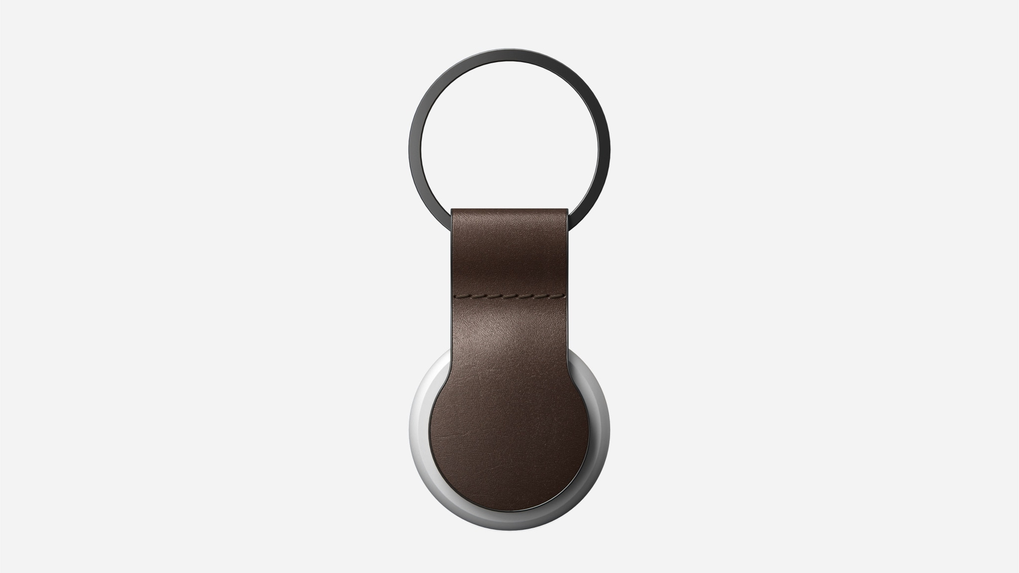 A brown leather keyring holding an AirTag