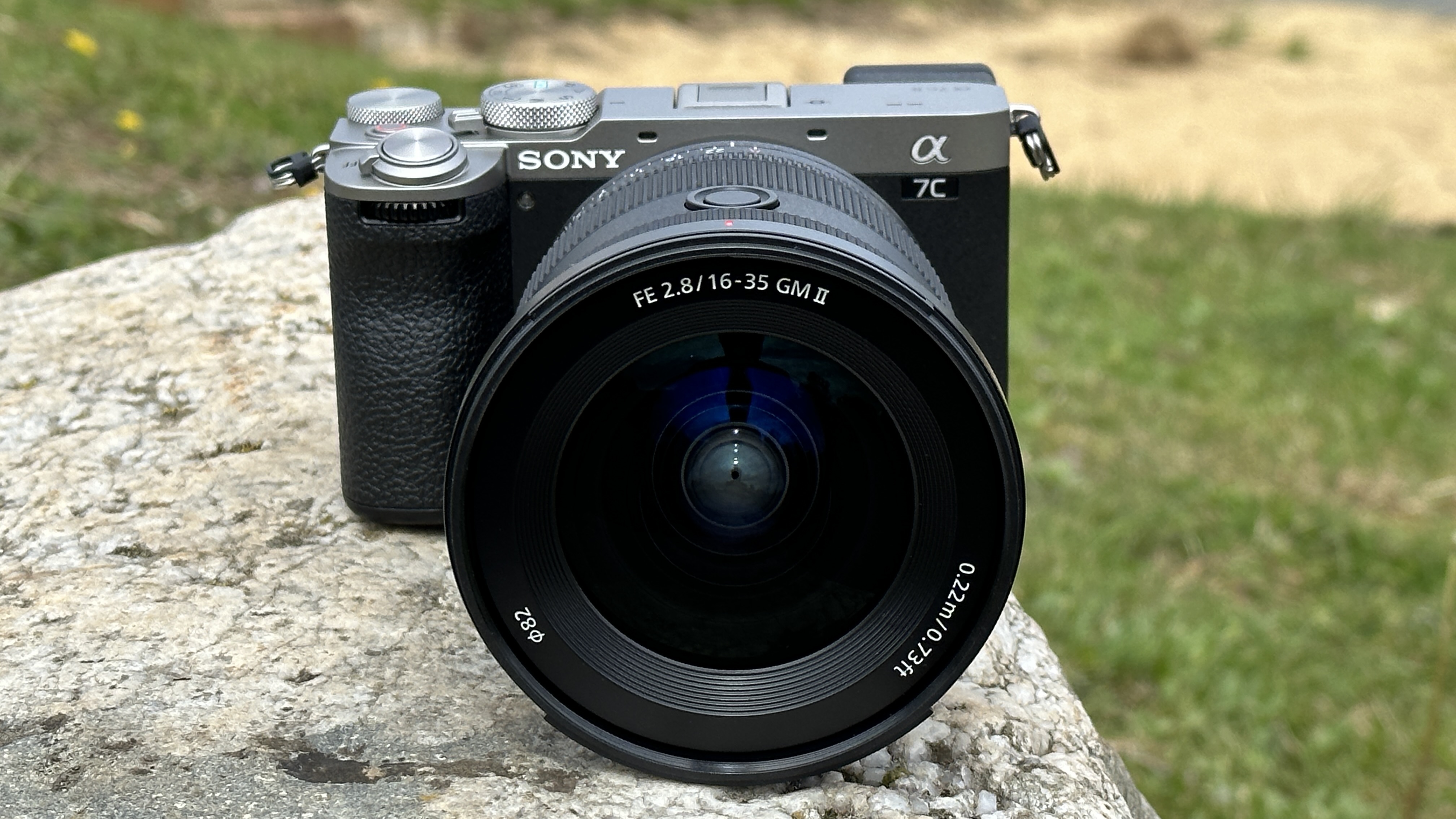 Sony A7C II mirrorless camera outside on a rock with Sony FE 16-35mm F2.8 GM II lens attached