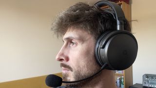 A man wearing the Audeze Maxwell 2 gaming headset