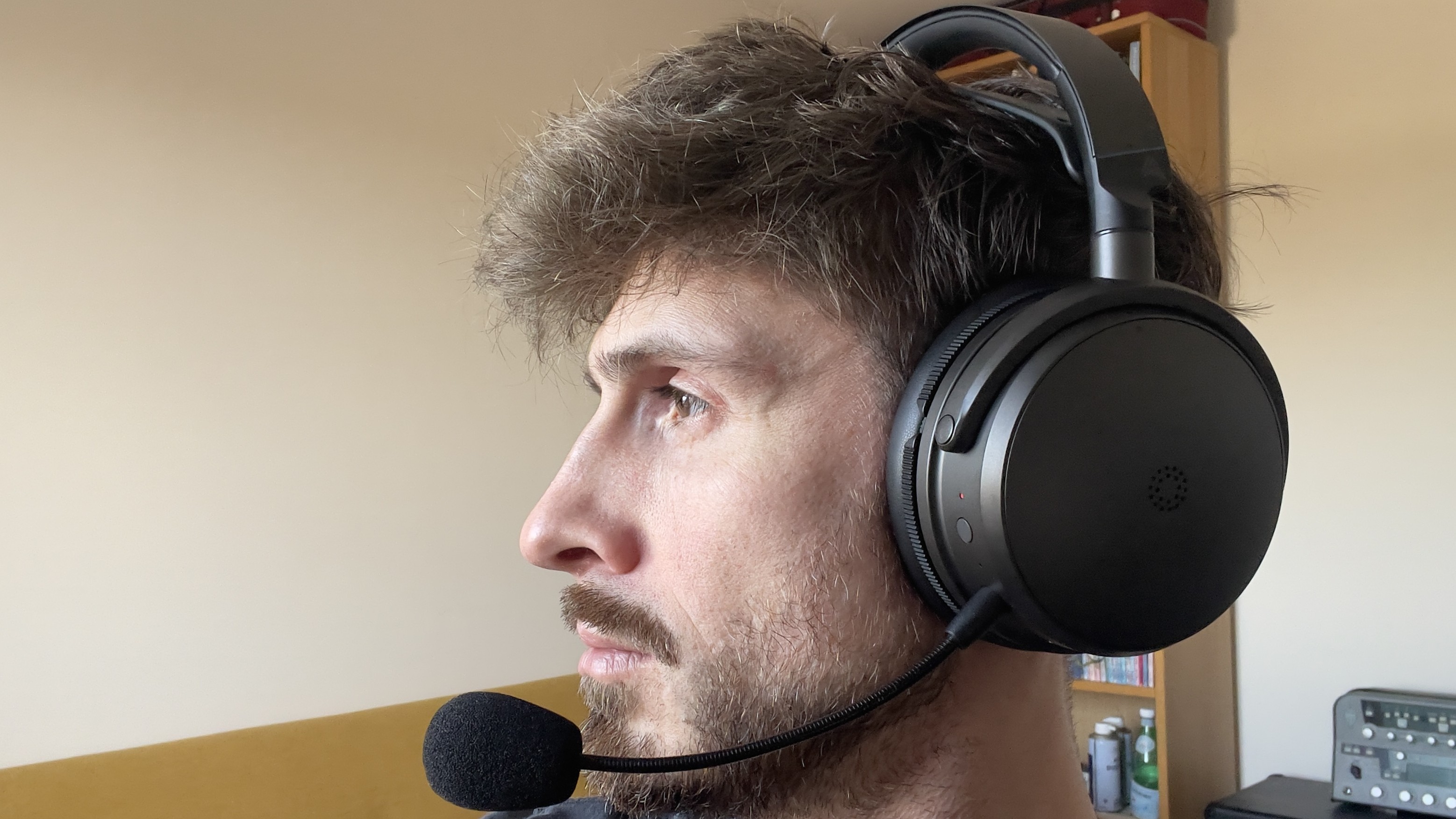 A man wearing the Audeze Maxwell 2 gaming headset