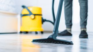 wet vacuuming the floor with a wet dry vacuum cleaner