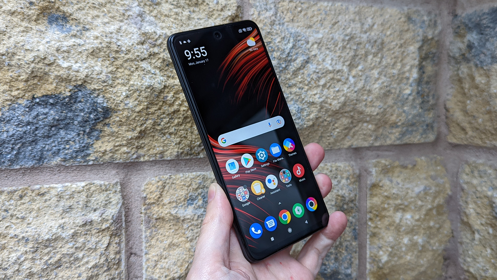 Xiaomi Poco M4 Pro 5G facing forward, being held up, with the screen on.