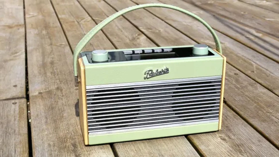 The Roberts Rambler DAB Radio outside on a  wooden table.