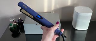The Hot Tools Pro Signature Digital Straightener being held in a hand