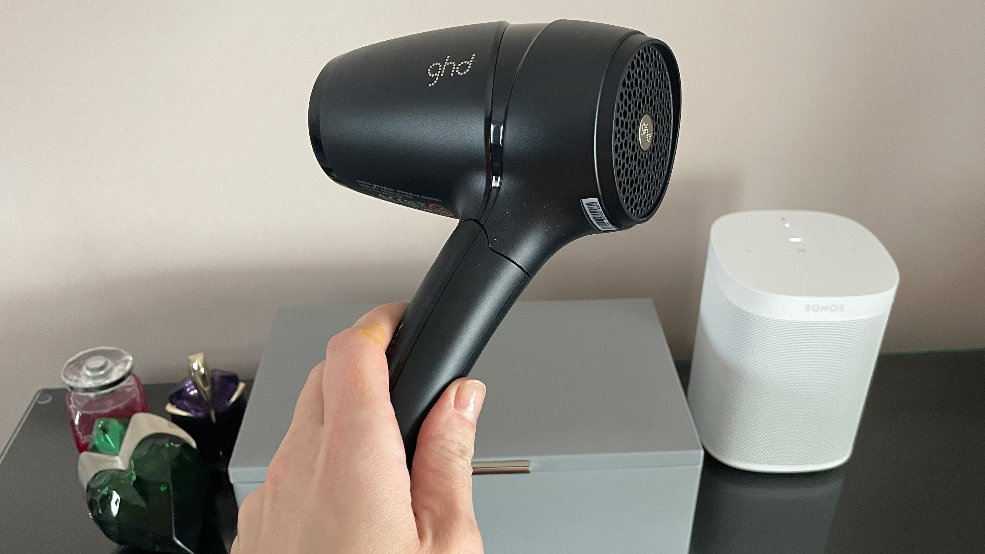 The GHD Flight being held in a hand