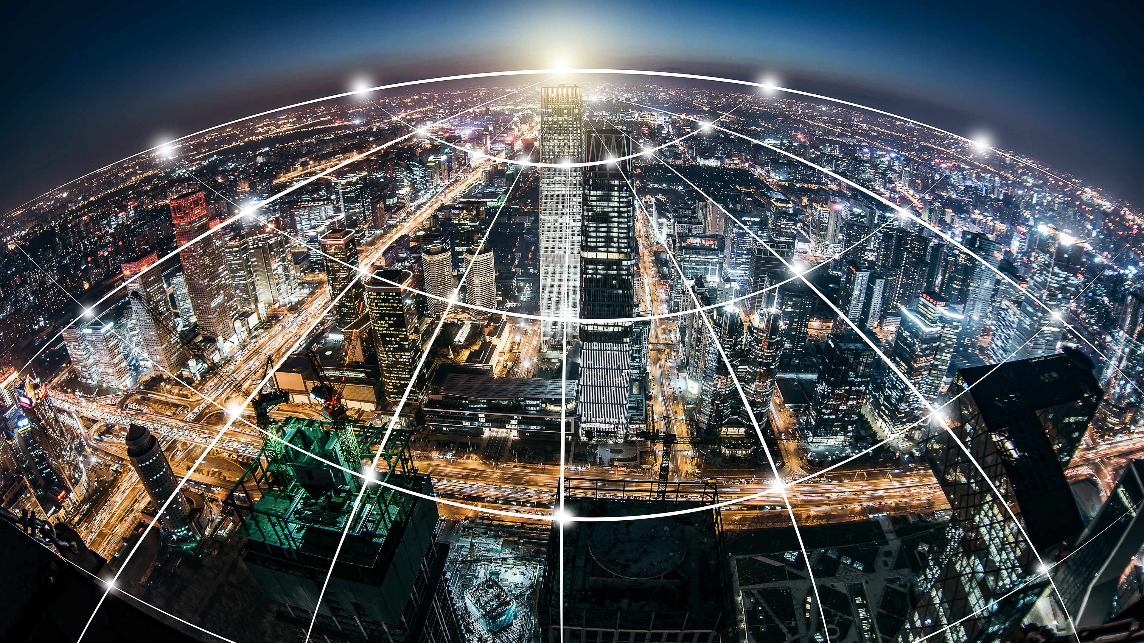 A digital grid criss-crossing the lights and buildings of a vast city below