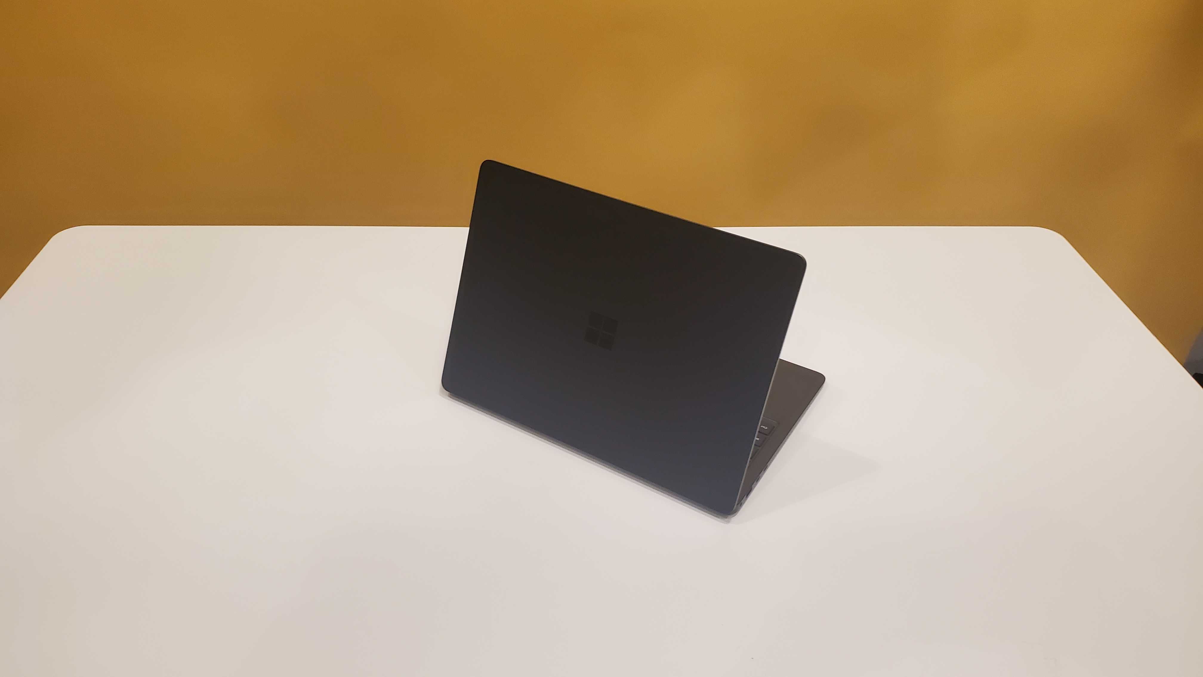 black laptop on white table