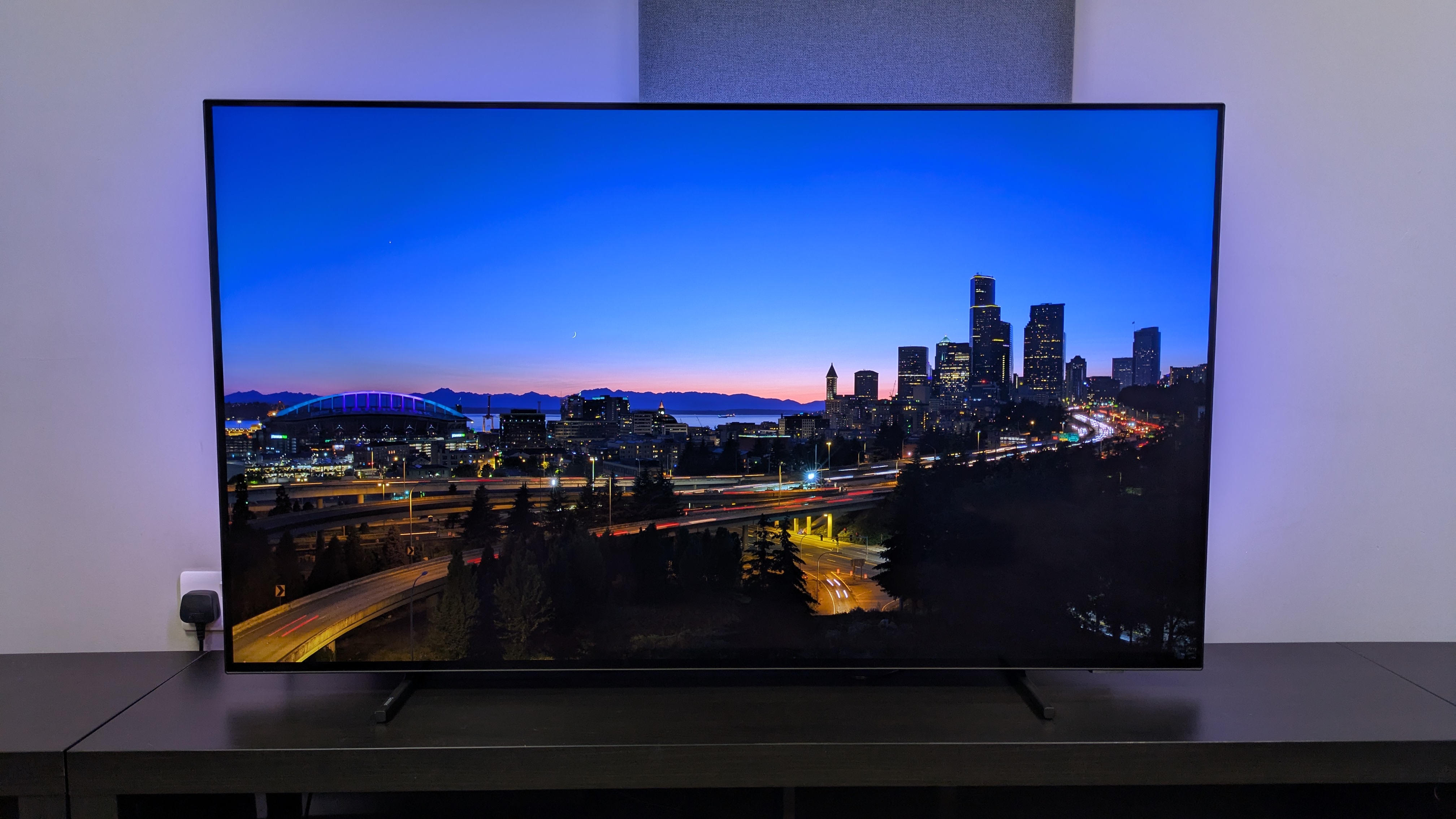 Philips OLED760 with a shot of a city skyline at dusk on screen