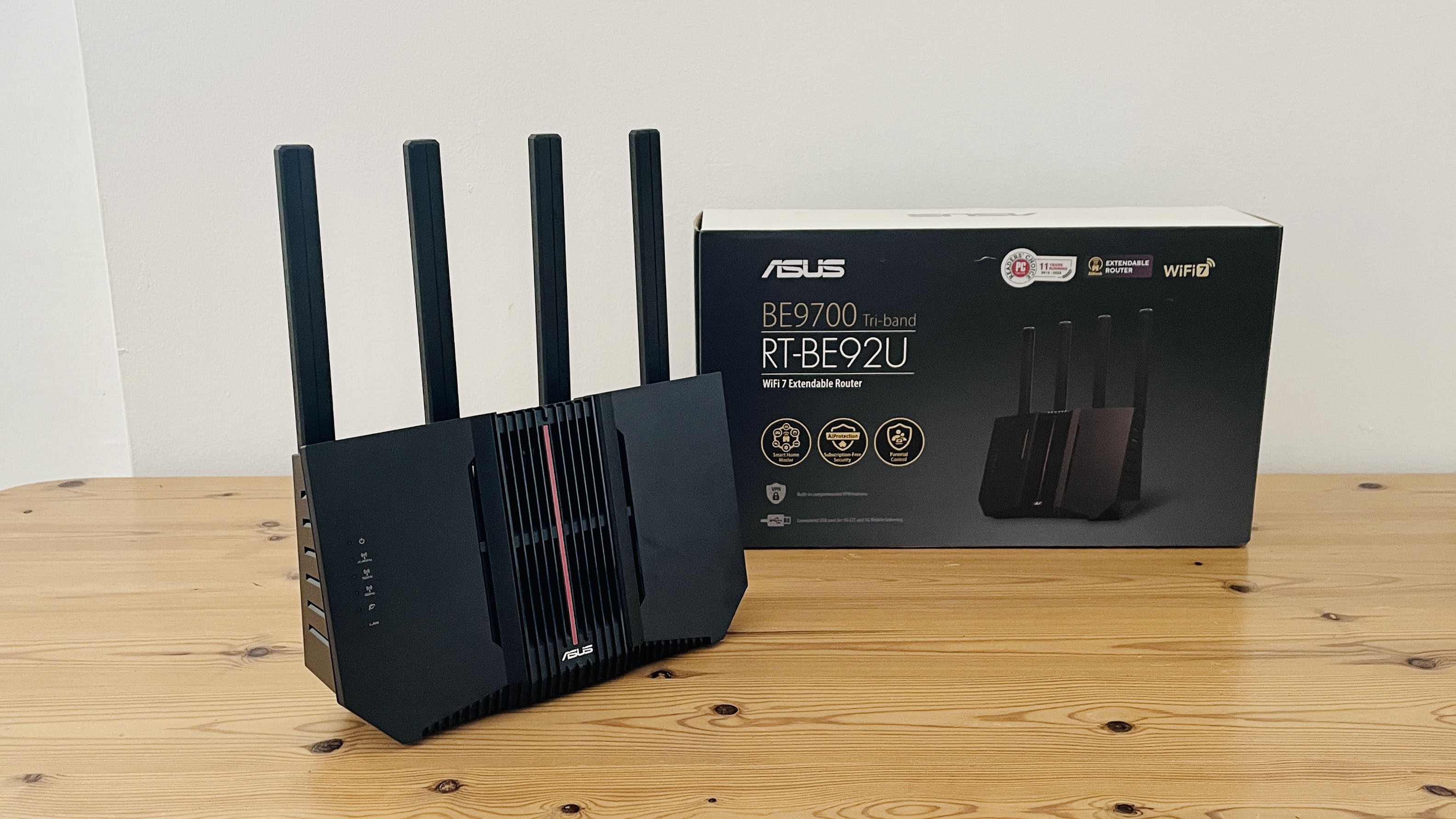 Asus RT-BE92U router on wooden table with box