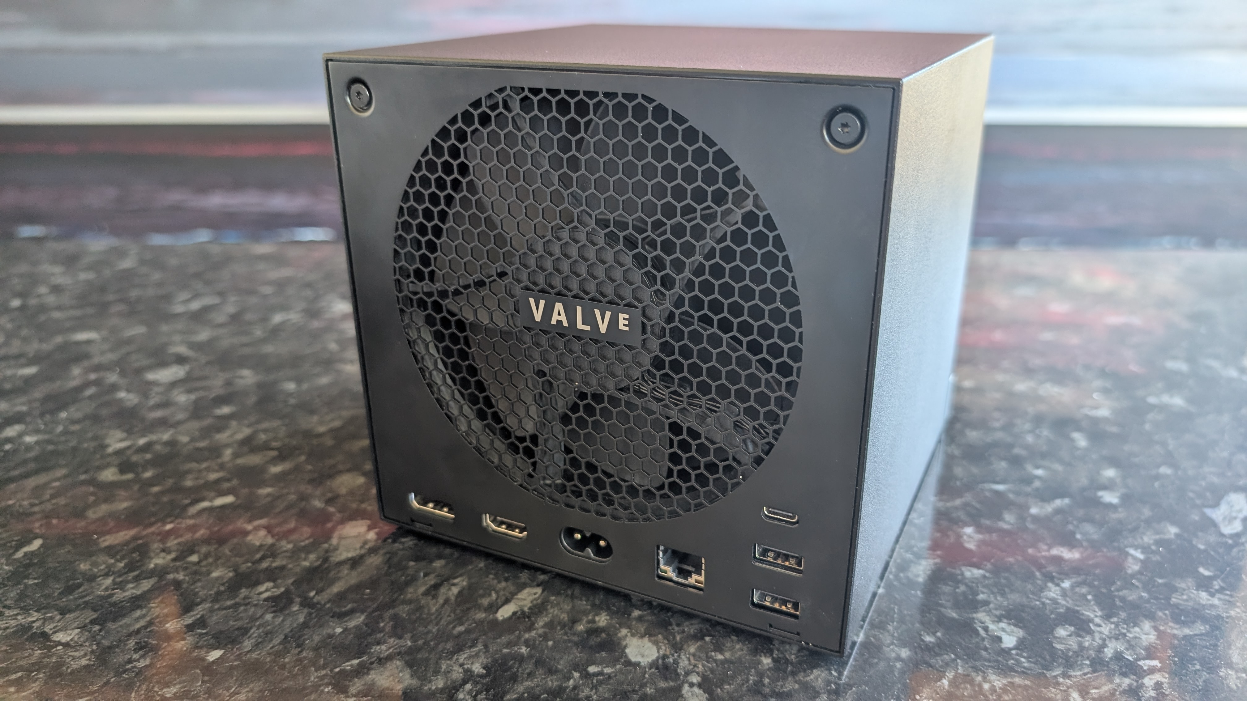 The Valve Steam Machine, pictured on a dark marble worktop.