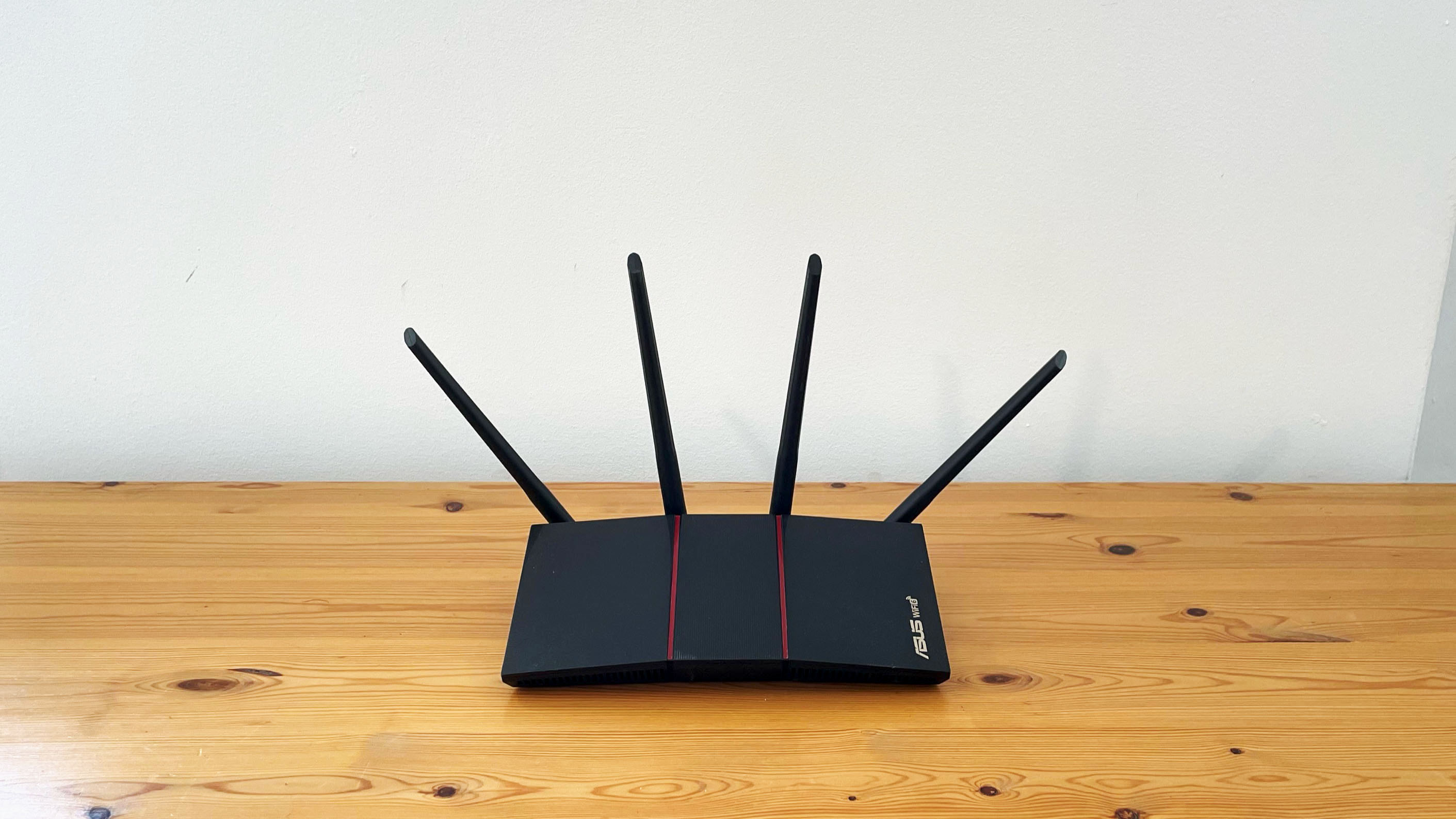 Asus RT-AX55 on a wood desk