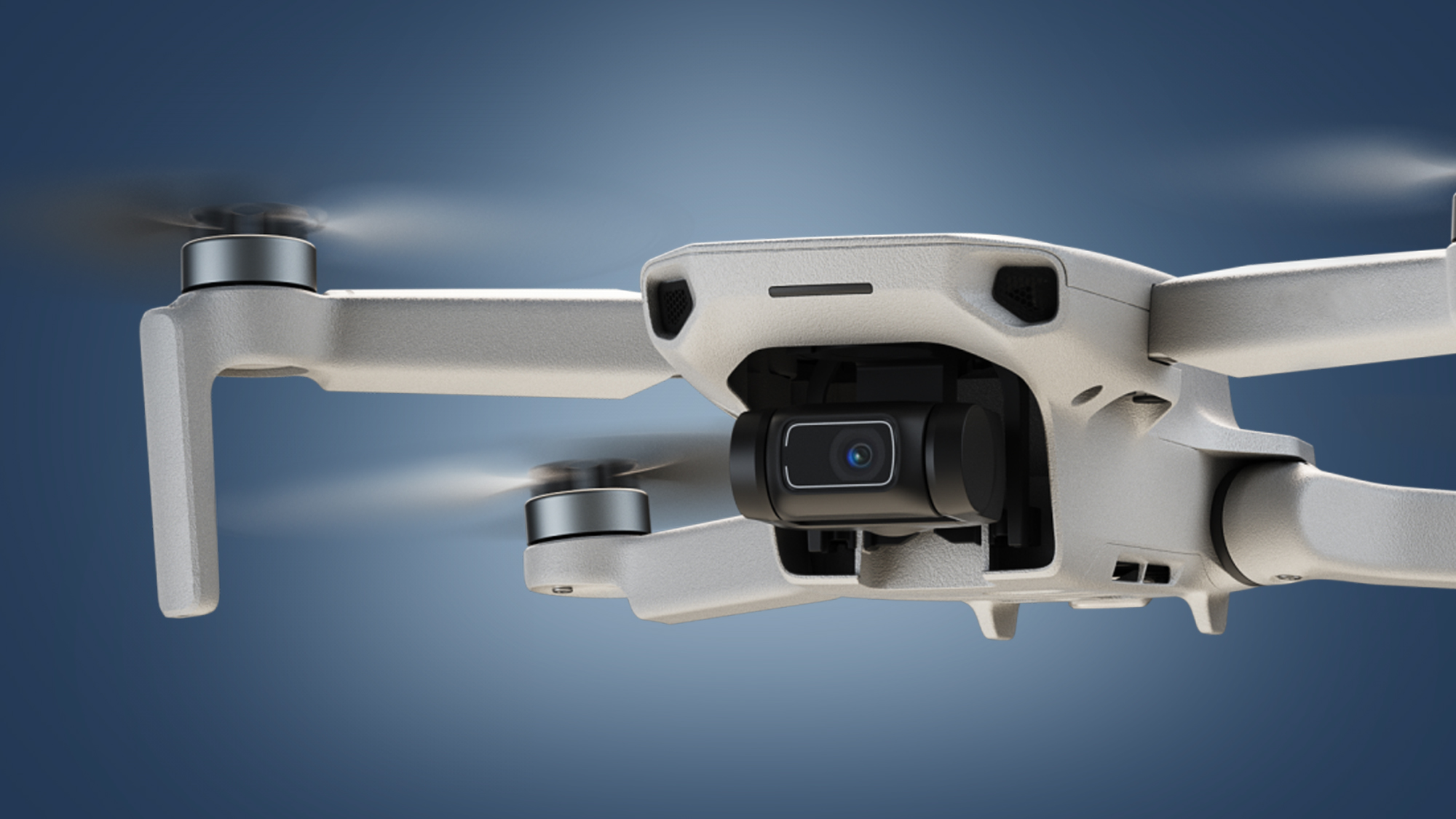 The DJI Mini 2 drone in flight on a blue background