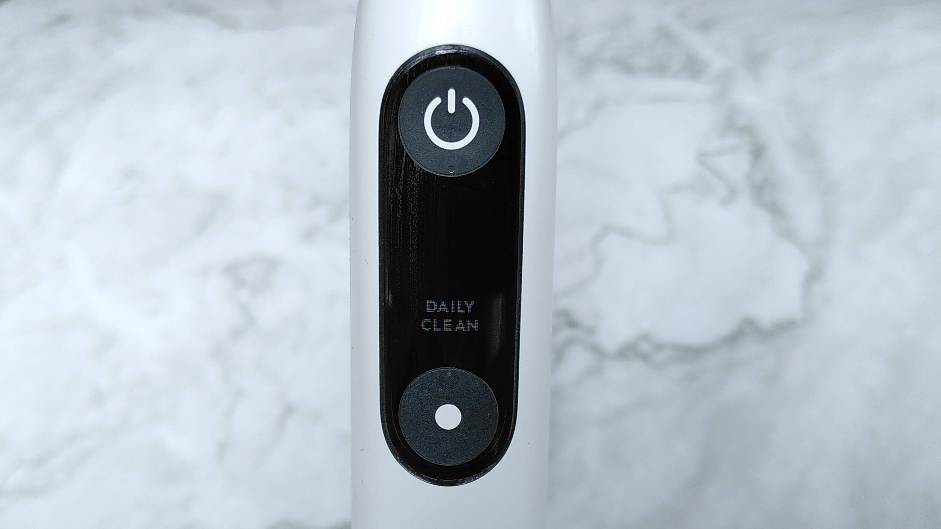 Close-up of Oral-B iO Series 9 power button and display
