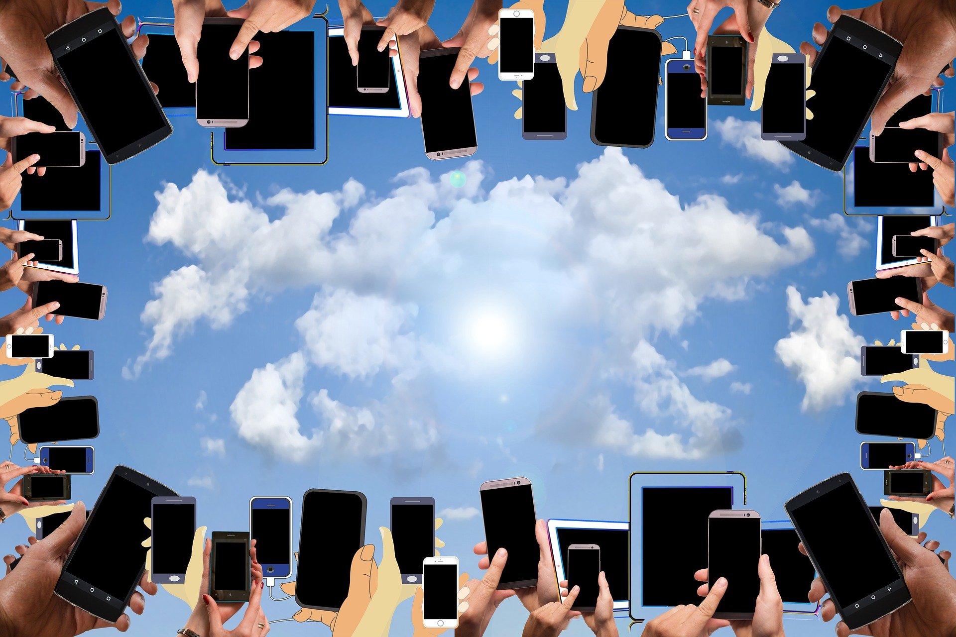 Lots of mobile devices being held up to the sky.