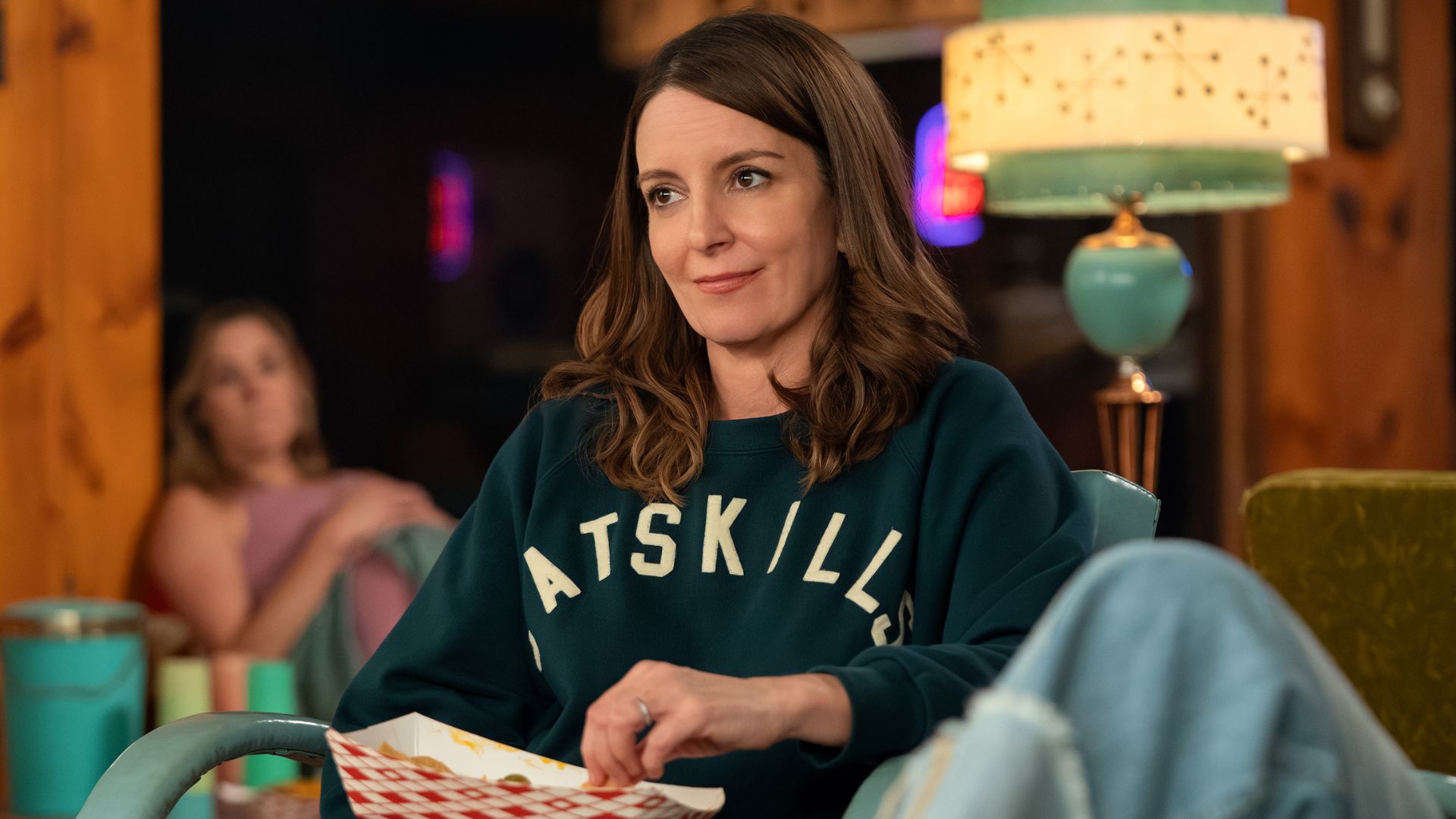 Tina Fey smiles at something offscreen