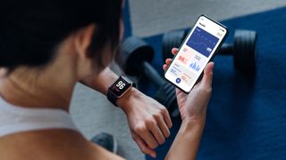 Woman checking fitness tracker
